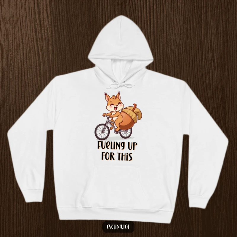 Funny squirrel hoodie showing a squirrel comically struggling to pedal a bike uphill while carrying an oversized acorn.